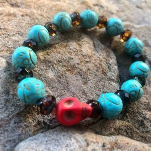 Turquoise colored round beads with red scull